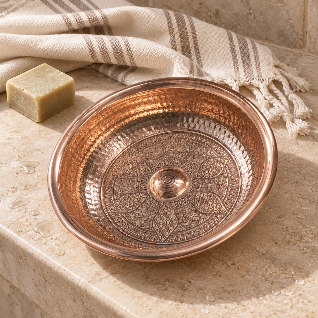 Doğal taş zeminde peştemal ve sabun yanında işlemeli bakır hamam tası